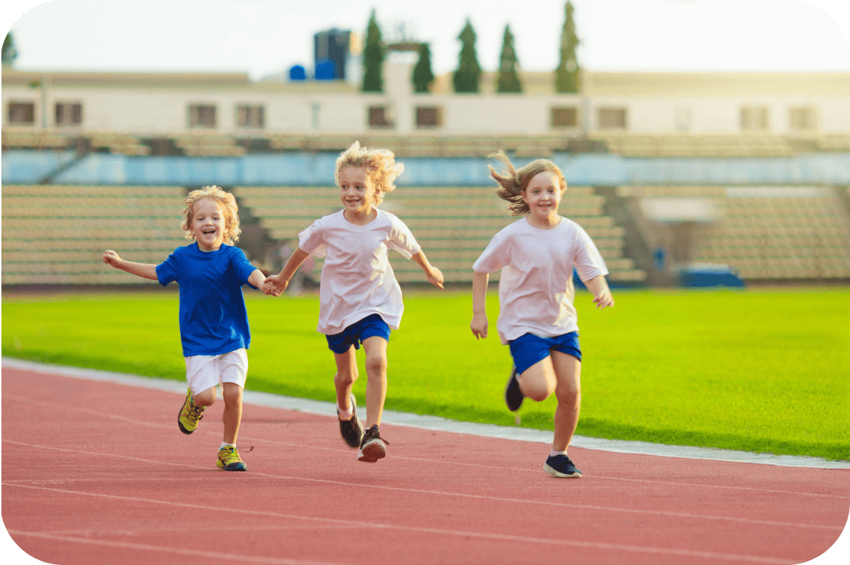 3 kids running in the field